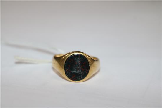 An early 20th century 18ct gold and bloodstone signet ring with carved turret matrix, size R.